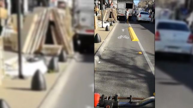 un ciclista se saco con comerciantes que estacionan sobre la bicisenda en calle 12